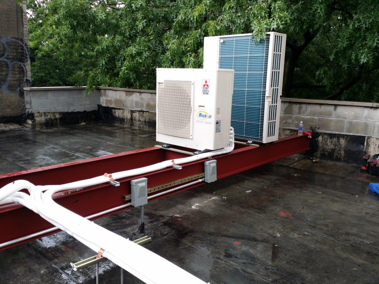 Ductless mini split condensers optimizing rooftop space for efficient cooling. ductless mini split condensers installed neatly on a rooftop